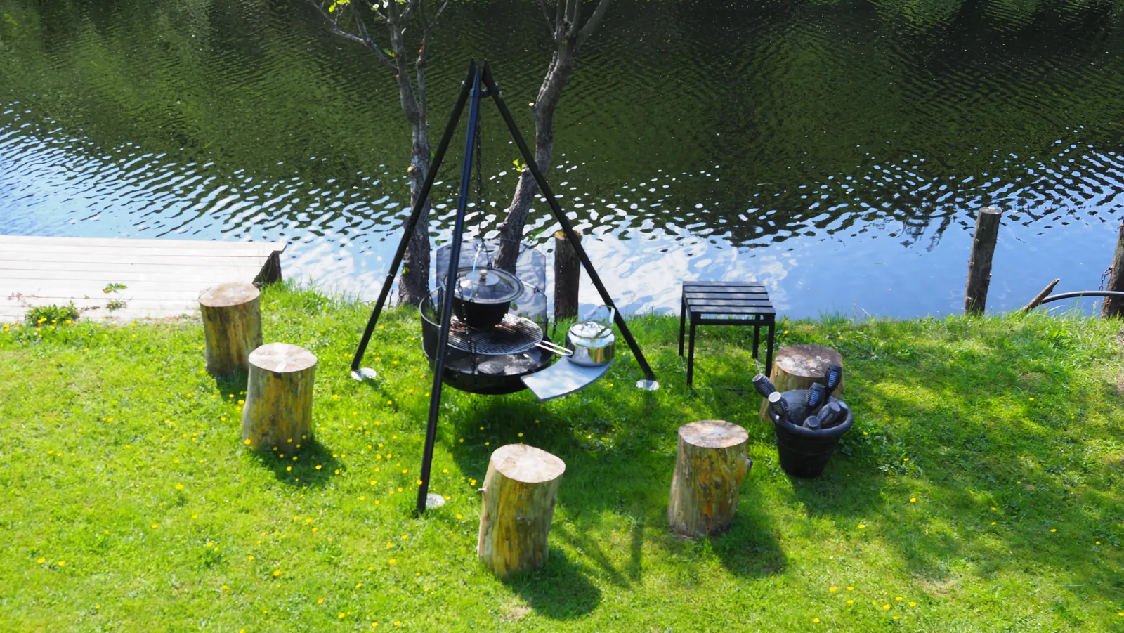 Fire cooking setup by the river at Riverside Bliss