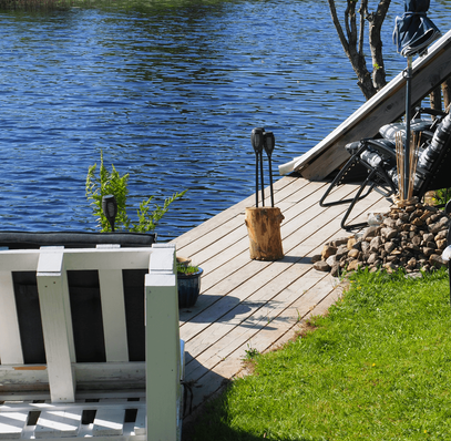 A sun lounger on a serene riverbank jetty, inviting relaxation amidst nature's beauty and the gentle flow of the tranquil river.